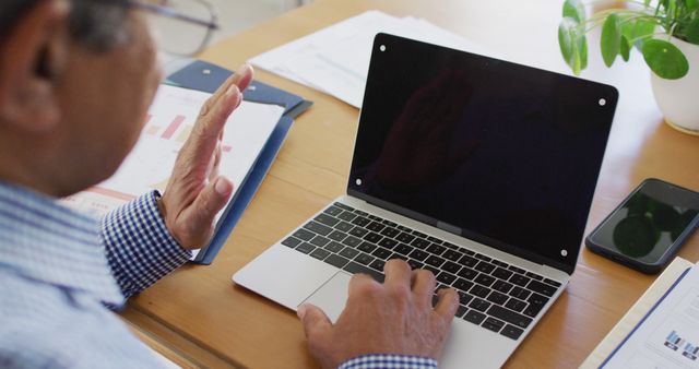 Businessman Using Laptop During Virtual Meeting in Office - Download Free Stock Images Pikwizard.com