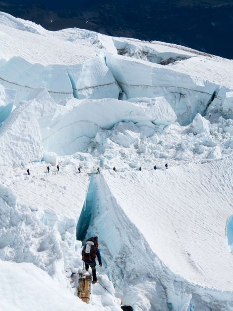 Mountaineer Crossing Ice Canyon on Himalayan Expedition  - Download Free Stock Photos Pikwizard.com