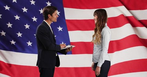 Business people interviewing in front of american flag