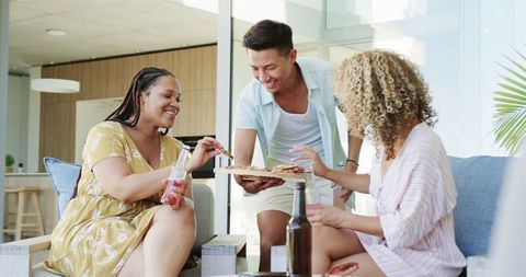 Diverse Friends Savoring Pizza in Casual Home Atmosphere