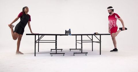 Multicultural Table Tennis Athletes Warming Up in Studio