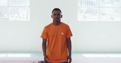 Confident Teenage Judoka in Orange T-Shirt Standing in Gym
