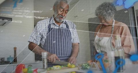 Senior Couple Cooking Together Prepping Fresh Vegetables at Home