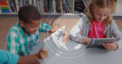 Children learning with tablets and world map overlay in classroom