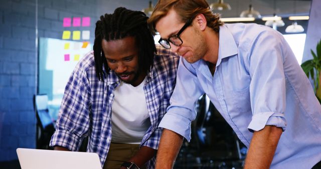 Multiracial Colleagues Collaborating on Laptop in Modern Office - Download Free Stock Images Pikwizard.com