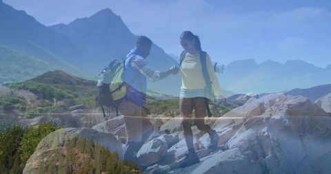 Adventurous Couple Hiking Together in Mountain Scenery