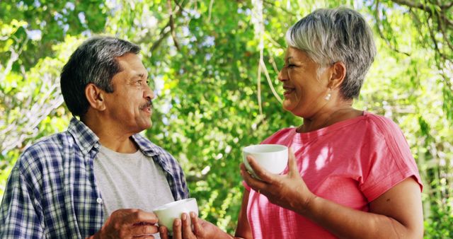 Smiling Senior Couple Enjoying Tea in Green Outdoors - Download Free Stock Images Pikwizard.com