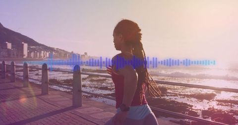 Active Woman Running Along Scenic Seaside Promenade at Sunrise