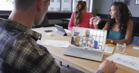 Diverse Business Team Engaged in Conference Call in Modern Office Workspace