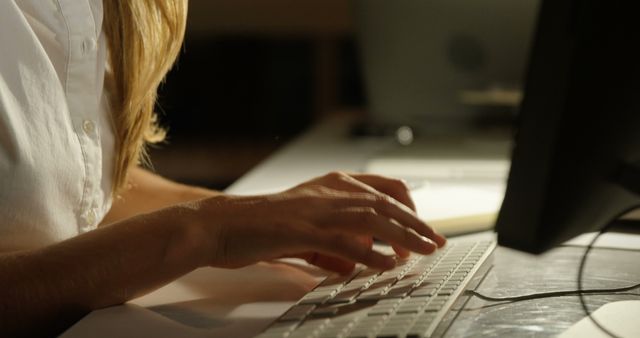 Woman Typing on Keyboard Late at Night in Dimly Lit Office - Download Free Stock Images Pikwizard.com
