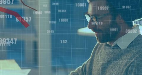 Businessman Analyzing Financial Trends on Laptop with Digital Data Overlay
