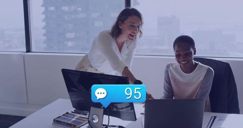 Two businesswomen discussing work with messaging medium overlay