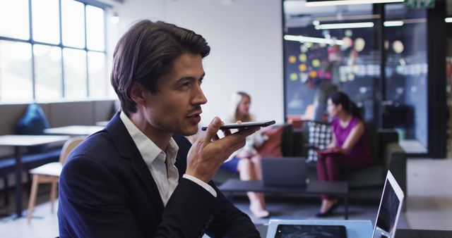 Businessman Dictating Using Smartphone in Modern Office - Download Free Stock Images Pikwizard.com