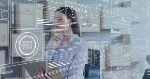 Studying augmented data dashboard, female analyst holding tablet in modern office workspace