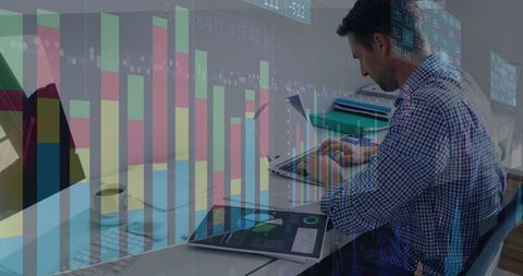 Focused Businessman Analyzing Financial Data with Charts and Tech - Download Free Stock Images Pikwizard.com