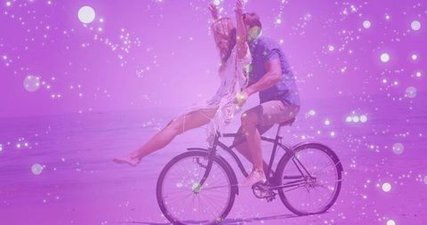 Joyful Couple Riding Bike Surrounded by Sparkling Energy Particles