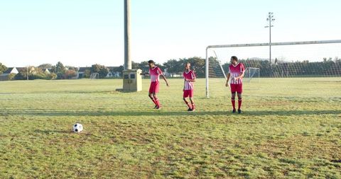 Soccer players forming wall on outdoor field