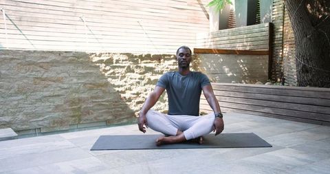 Man Practicing Meditation Outdoors in Serene Backyard Setting