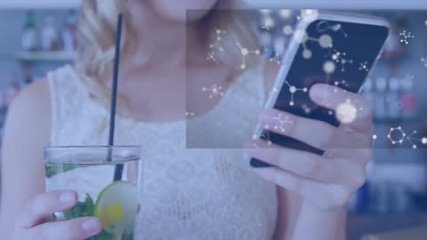 Caucasian Woman Using Smartphone while Holding a Healthy Beverage