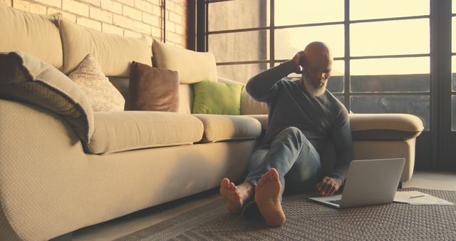 Senior Man Relaxing on Floor with Laptop in Modern Living Room - Download Free Stock Images Pikwizard.com