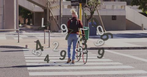 Urban Cyclist Crossing Street While Walking Bike on Sunny Day