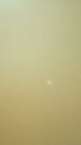 Minimalist vertical video showing subtle wall color shift with bright spot and copy space