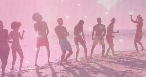 Group of Friends Dancing on Beach at Sunrise