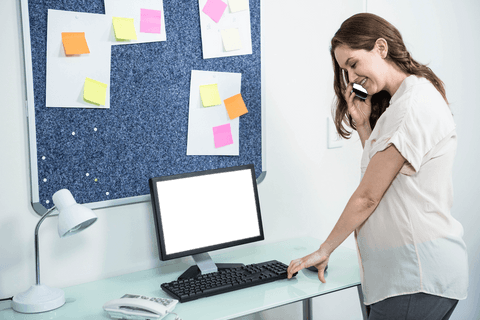 Pregnant woman in home office with transparent computer monitor frame
