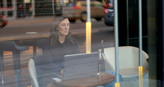 Woman Working Remotely in Urban Cafe with Laptop - Download Free Stock Images Pikwizard.com