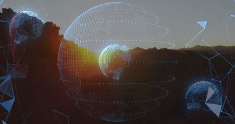 Futuristic wireframe globes above mountain at sunset