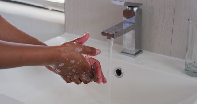 Close up of african american woman washing her hands in the bathroom sink at home - Download Free Stock Photos Pikwizard.com