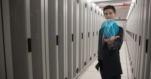 Businessman Holding Holographic Globe in Data Center - Download Free Stock Images Pikwizard.com