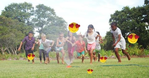 Diverse Kids Playing In Sprinkler Embracing Fun With Emoji