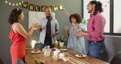 Happy Multiracial Friends Toasting at Housewarming Celebration