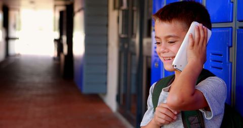 Joyful Elementary Student Chatting in School Corridor