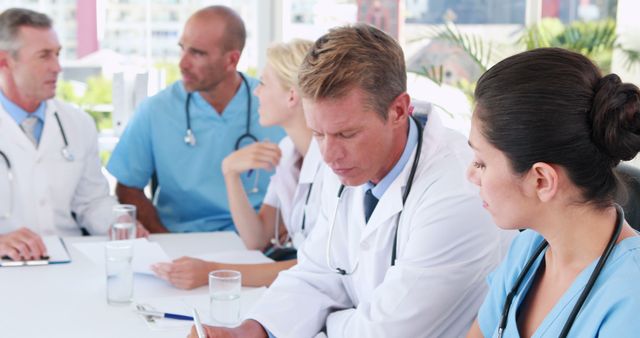 Medical team discussing treatment plan in hospital conference room - Download Free Stock Images Pikwizard.com