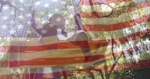 Father and Son Enjoying Swinging Outdoors with American Flag Overlay