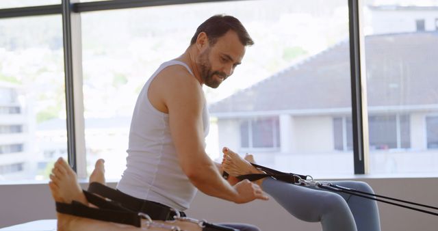 Trainer Assisting in Pilates Workout at Gym - Download Free Stock Images Pikwizard.com