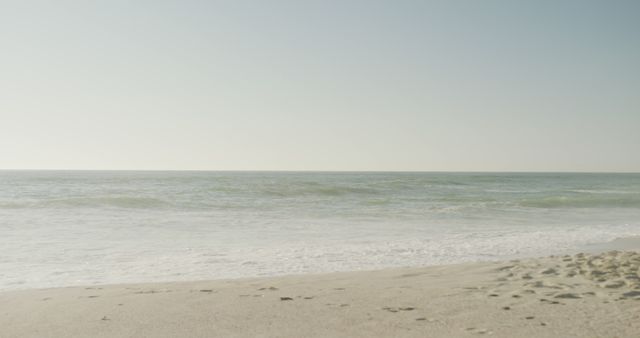 Tranquil Ocean Waves and Sandy Beach Under Clear Sky - Download Free Stock Images Pikwizard.com