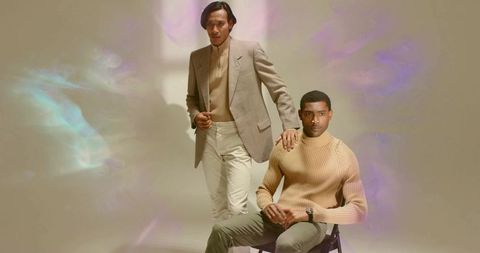 Male models in beige sweaters and blazer in contemporary studio