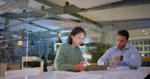 Diverse Team Engaging in Evening Office Discussion