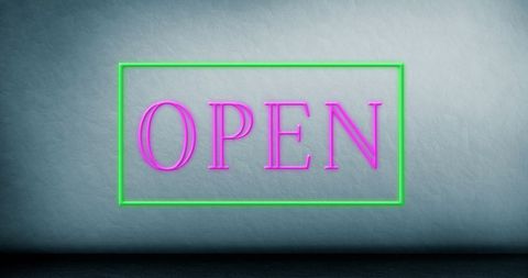 Neon open sign with pink glow and green frame against blue background