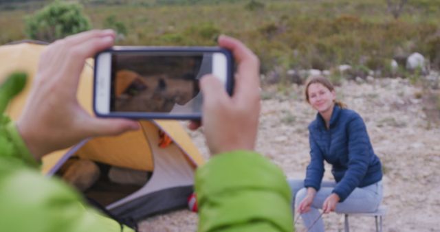 Camping Adventure: Woman Cooking by Campfire Captured on Smartphone - Download Free Stock Images Pikwizard.com