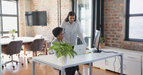 Diverse Female Coworkers Collaborating in Modern Office Space