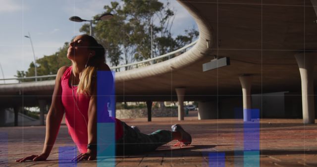 A young woman is stretching during a workout under a bridge. Global connections sports fitness and data processing concept digitally generated image.
