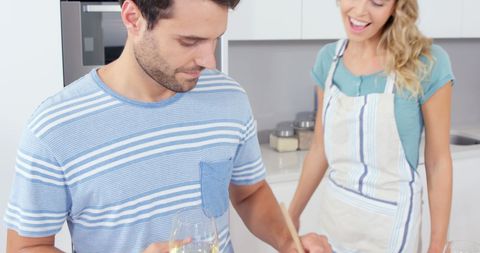Young Couple Cooking Together in Modern Bright Kitchen