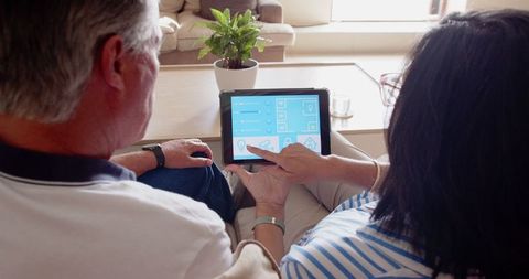 Senior Couple Using Tablet at Home for Modern Living Solutions