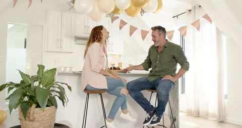 Mature Couple Enjoying Modern Kitchen Celebration