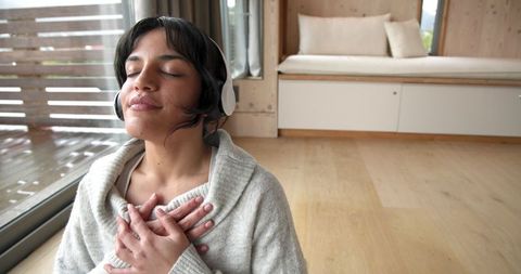 Woman Relaxing with Headphones in Modern Minimalist Living Room