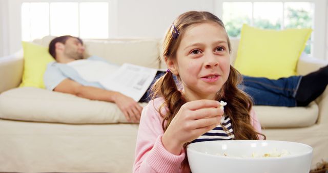 Portrait of girl eating popcorn in the living room at home 4k - Download Free Stock Photos Pikwizard.com